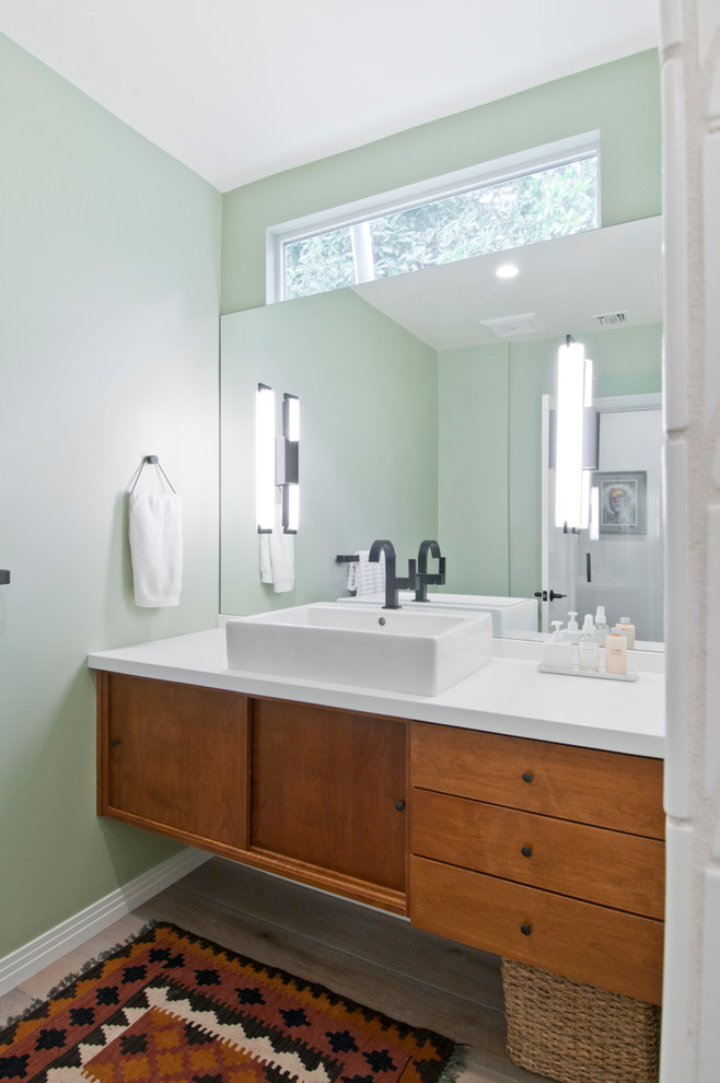 Mid-sized midcentury master bathroom in Los Angeles with furniture-like cabinets, medium wood cabinets, a corner shower, green tile, ceramic tile, engineered quartz benchtops and a hinged shower door.