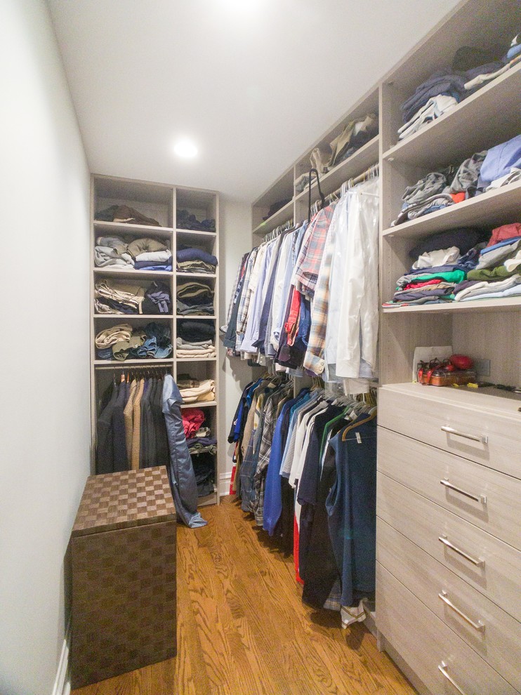 Large transitional gender-neutral walk-in wardrobe in Chicago with flat-panel cabinets, light wood cabinets, medium hardwood floors and brown floor.