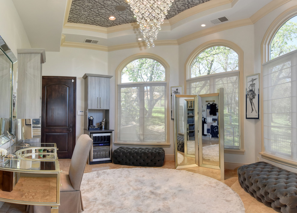 Design ideas for an expansive transitional women's dressing room in Sacramento with open cabinets, grey cabinets, limestone floors and beige floor.