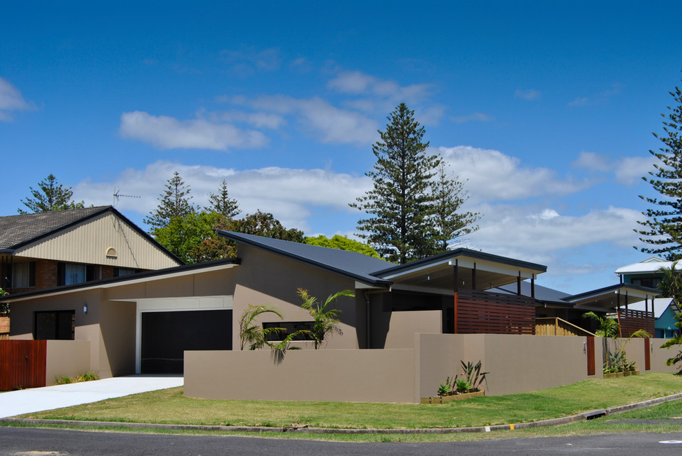 Mid-sized contemporary one-storey stucco brown exterior in Other with a shed roof.