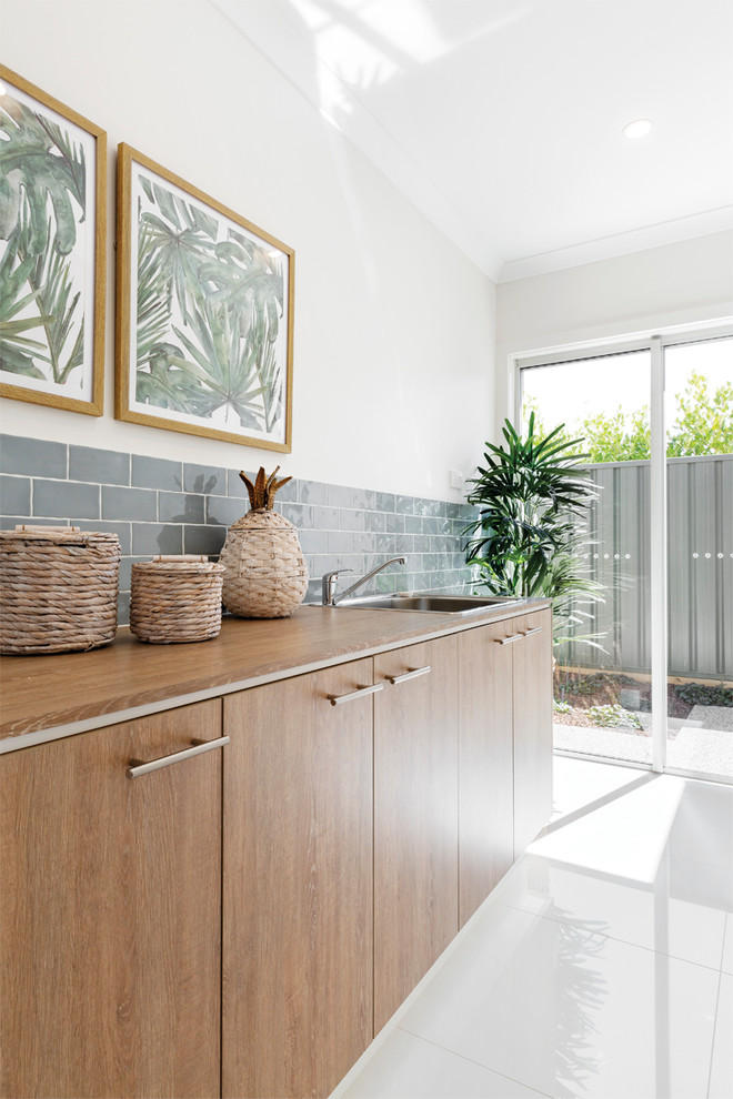Beach style laundry room in Melbourne.