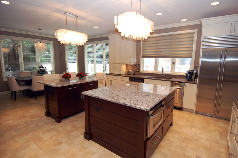 Inspiration for a large transitional l-shaped eat-in kitchen remodel in Chicago with shaker cabinets, white cabinets, mosaic tile backsplash, gray walls, an undermount sink, granite countertops, metallic backsplash, two islands and stainless steel appliances