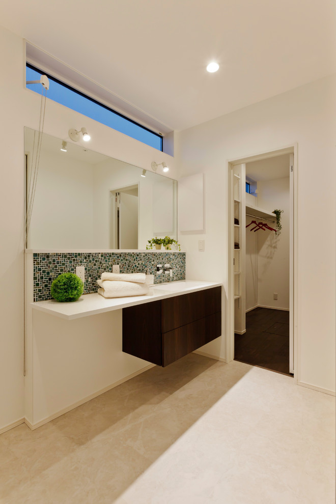 Photo of a modern powder room in Other with dark wood cabinets, multi-coloured tile, white walls, beige floor and white benchtops.