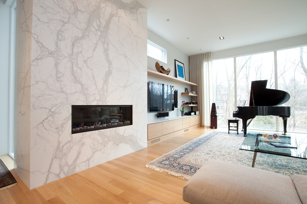 Photo of a mid-sized contemporary open concept living room in Toronto with a music area, medium hardwood floors, a ribbon fireplace and a wall-mounted tv.