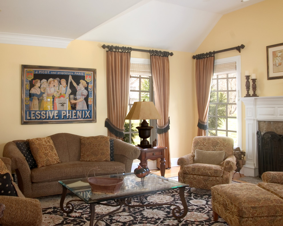 Large traditional enclosed living room in Atlanta with yellow walls, a standard fireplace, medium hardwood floors, a tile fireplace surround and no tv.