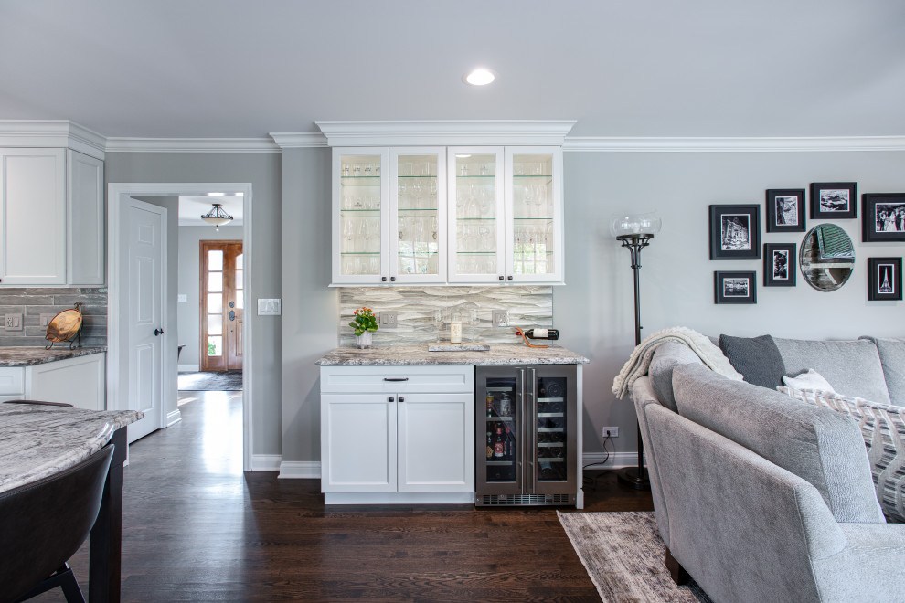 Example of a mid-sized transitional u-shaped dark wood floor and brown floor open concept kitchen design in Chicago with a double-bowl sink, shaker cabinets, white cabinets, quartz countertops, blue backsplash, porcelain backsplash, stainless steel appliances, an island and gray countertops