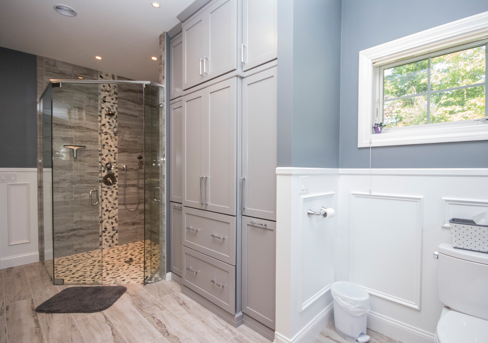 Inspiration for an expansive modern master bathroom in Providence with recessed-panel cabinets, grey cabinets, a corner shower, a two-piece toilet, multi-coloured tile, porcelain tile, grey walls, porcelain floors, an undermount sink, quartzite benchtops, beige floor and a hinged shower door.