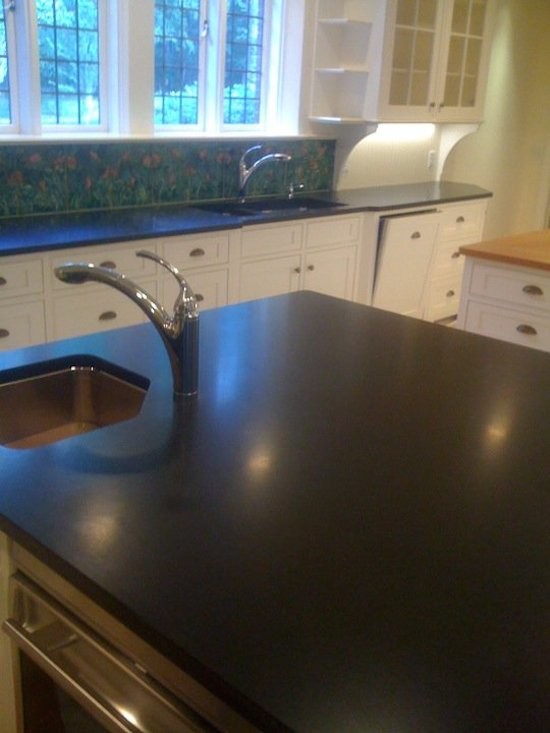 Transitional kitchen photo in Boston with an undermount sink, white cabinets, granite countertops, green backsplash and stainless steel appliances