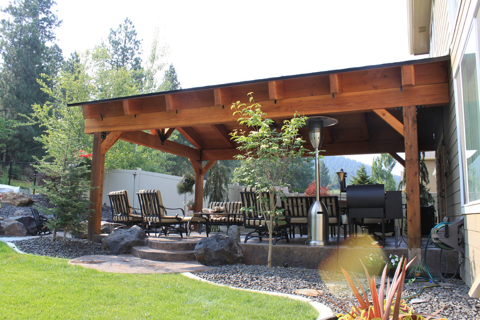 Inspiration for a large arts and crafts backyard patio in Seattle with a roof extension.