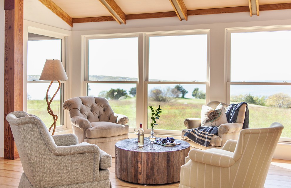 Photo of a beach style sunroom in New York with light hardwood floors, no fireplace and a standard ceiling.