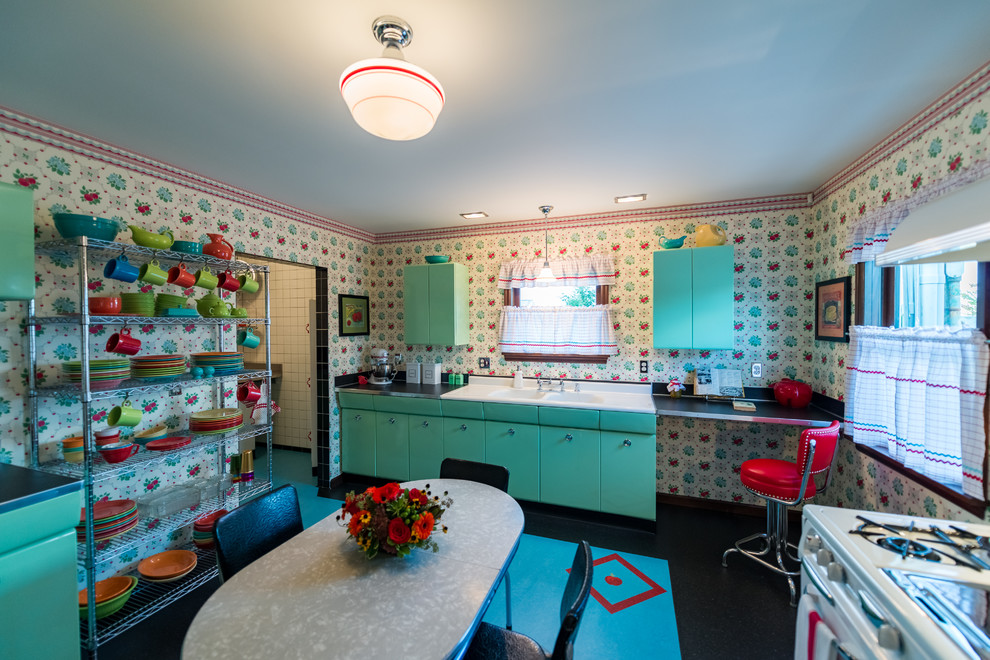 Mid-sized midcentury l-shaped separate kitchen in Seattle with a double-bowl sink, louvered cabinets, green cabinets, yellow splashback, linoleum floors and no island.
