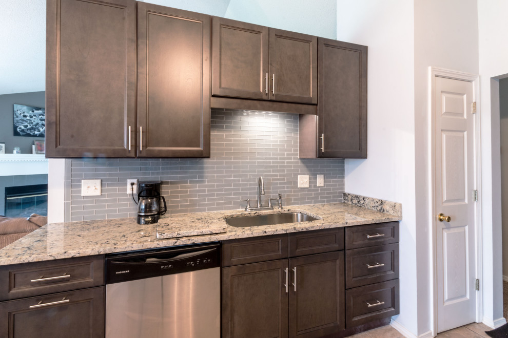 Inspiration for a small galley cement tile floor and beige floor eat-in kitchen remodel with an undermount sink, flat-panel cabinets, gray cabinets, granite countertops, gray backsplash, glass tile backsplash, stainless steel appliances, no island and white countertops