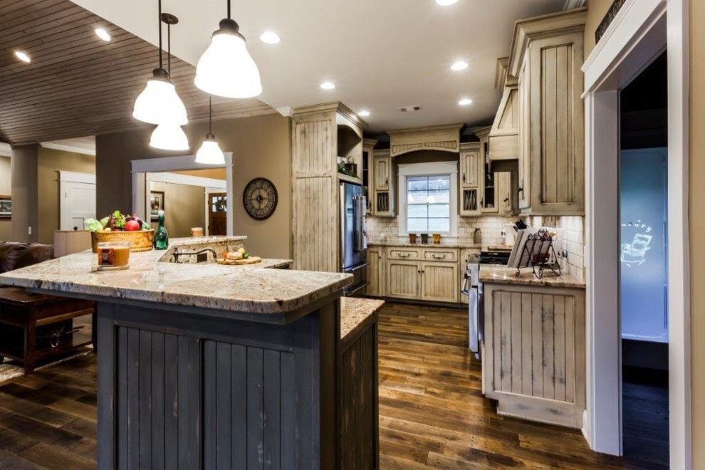 Mid-sized country u-shaped eat-in kitchen in Other with recessed-panel cabinets, distressed cabinets, granite benchtops, white splashback, subway tile splashback, stainless steel appliances, dark hardwood floors, with island and brown floor.