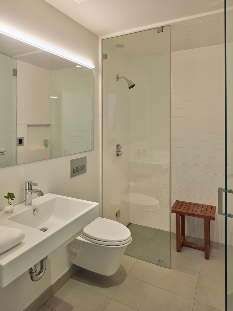 Contemporary bathroom in San Francisco with a curbless shower, white tile, white walls, a wall-mount sink, grey floor, an open shower, a wall-mount toilet and porcelain floors.