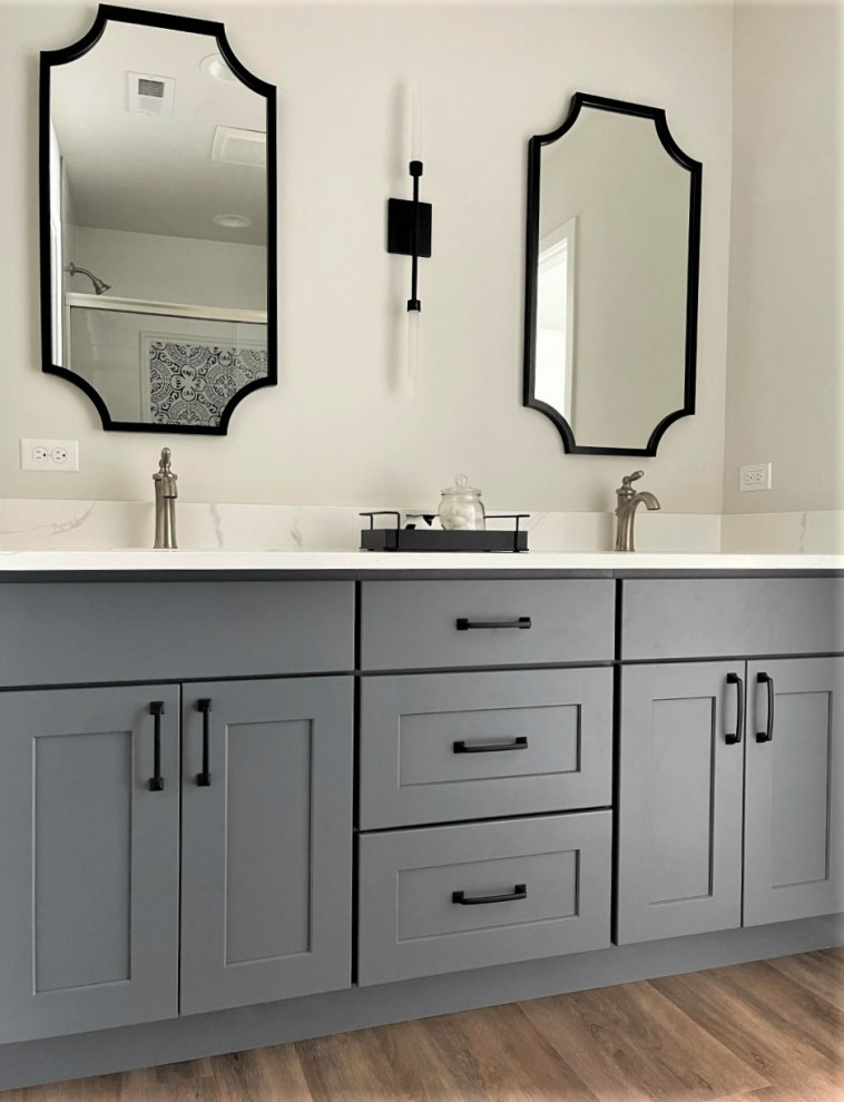 Inspiration for a small transitional bathroom in Chicago with shaker cabinets, blue cabinets, vinyl floors, engineered quartz benchtops, brown floor, a sliding shower screen, white benchtops, a double vanity, a built-in vanity, an alcove shower, an undermount sink and an enclosed toilet.