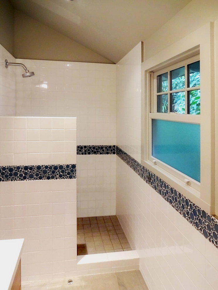 Inspiration for a mid-sized beach style 3/4 bathroom in San Francisco with a drop-in sink, flat-panel cabinets, light wood cabinets, engineered quartz benchtops, an alcove shower, a one-piece toilet, yellow tile, ceramic tile, beige walls and ceramic floors.