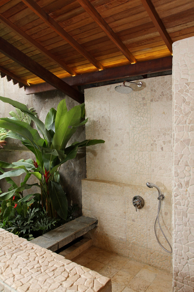 Photo of a tropical patio with an outdoor shower.