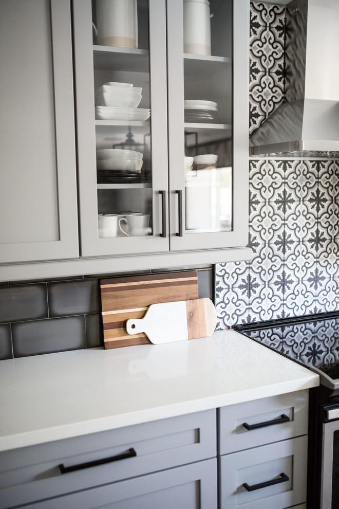 Example of a mid-sized transitional u-shaped light wood floor and gray floor eat-in kitchen design in Phoenix with an undermount sink, recessed-panel cabinets, gray cabinets, quartz countertops, multicolored backsplash, ceramic backsplash, stainless steel appliances, an island and white countertops