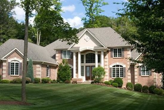 Inspiration for a front yard brick landscaping.