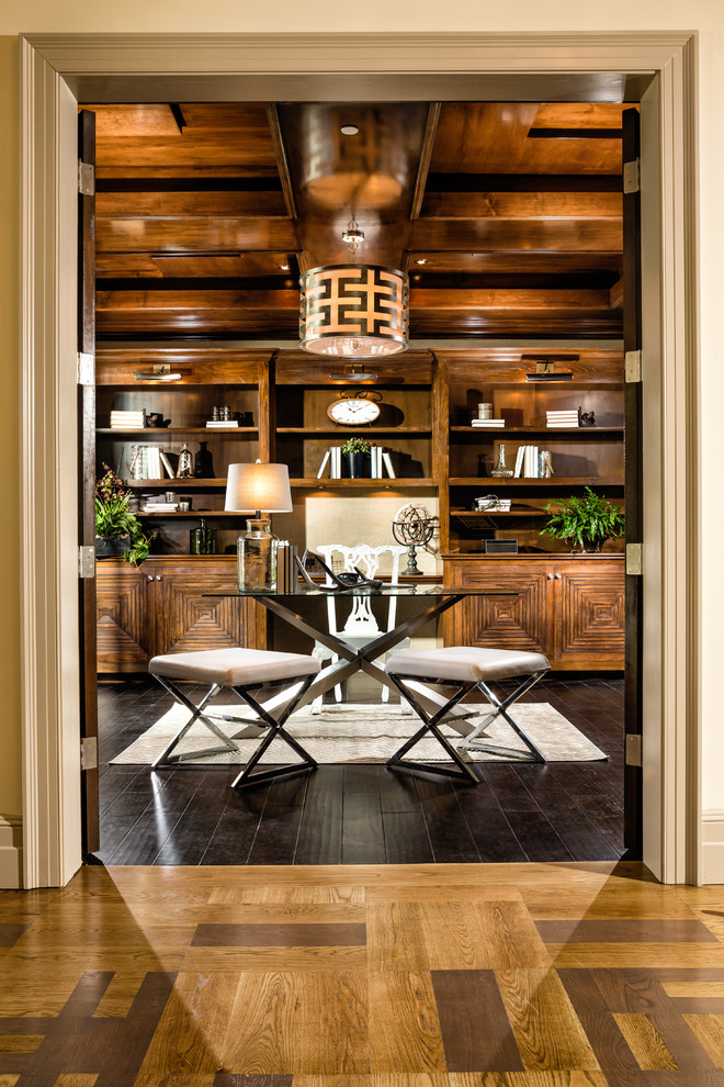 Inspiration for a tropical home office in Los Angeles with dark hardwood floors, a freestanding desk and brown floor.
