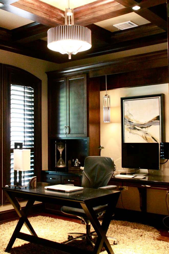 This is an example of a small contemporary study room in Dallas with beige walls, dark hardwood floors and a freestanding desk.
