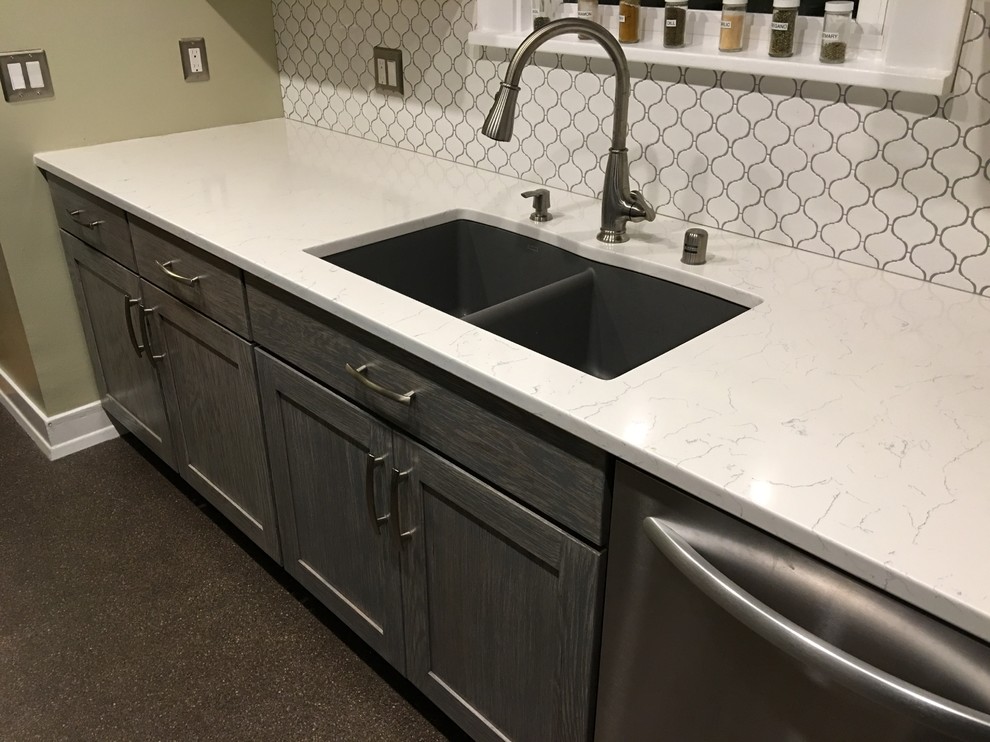 Inspiration for a small transitional galley enclosed kitchen remodel in Seattle with an undermount sink, shaker cabinets, gray cabinets, quartzite countertops, white backsplash, ceramic backsplash, stainless steel appliances and no island
