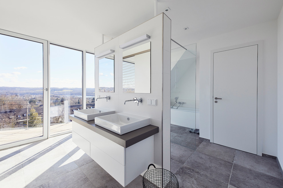Inspiration for a large modern 3/4 bathroom in Essen with flat-panel cabinets, white cabinets, an open shower, white tile, ceramic tile, white walls, slate floors, a vessel sink, grey floor, an open shower and brown benchtops.