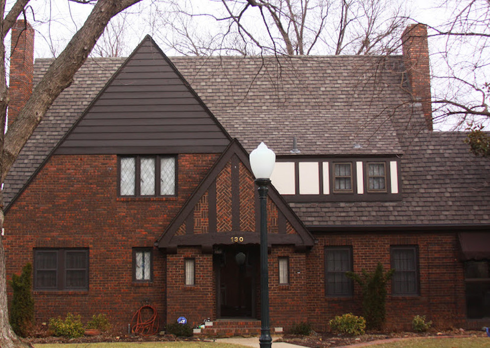 Photo of a large traditional two-storey brick red exterior in Wichita with a gable roof.