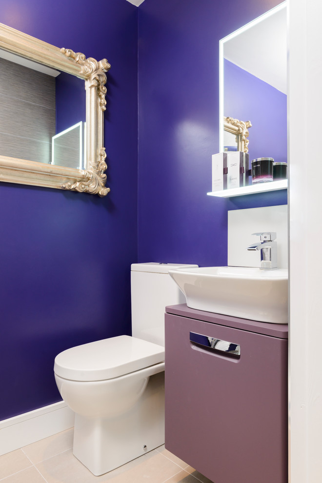 Photo of a small eclectic powder room in Other with flat-panel cabinets, purple cabinets, purple walls and purple benchtops.