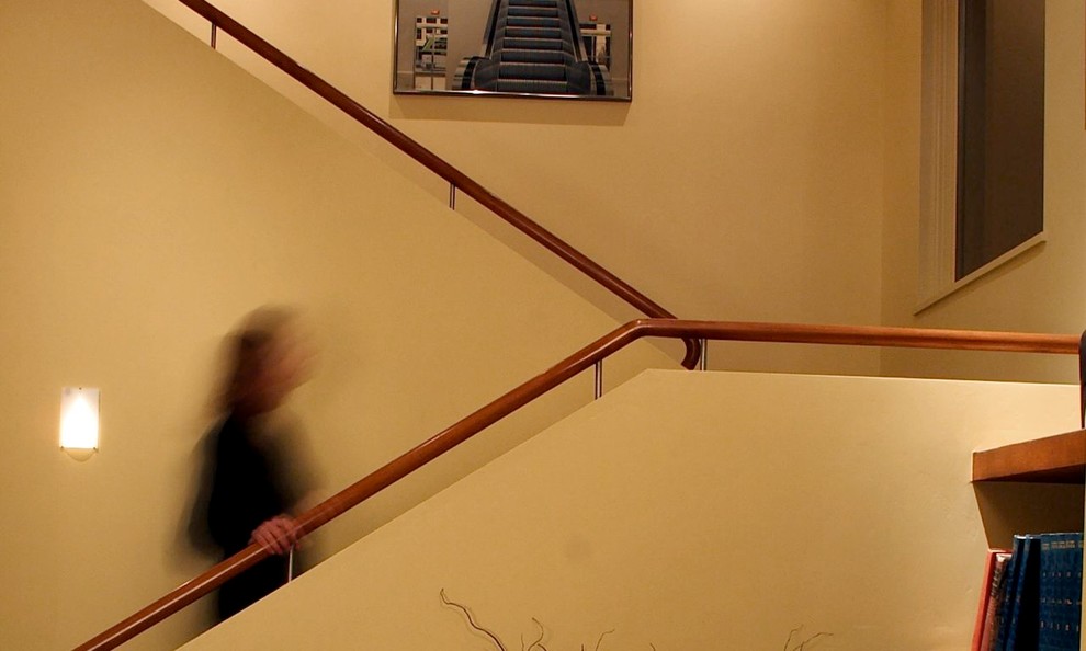 Inspiration for a small contemporary carpeted u-shaped staircase in Denver with carpet risers.