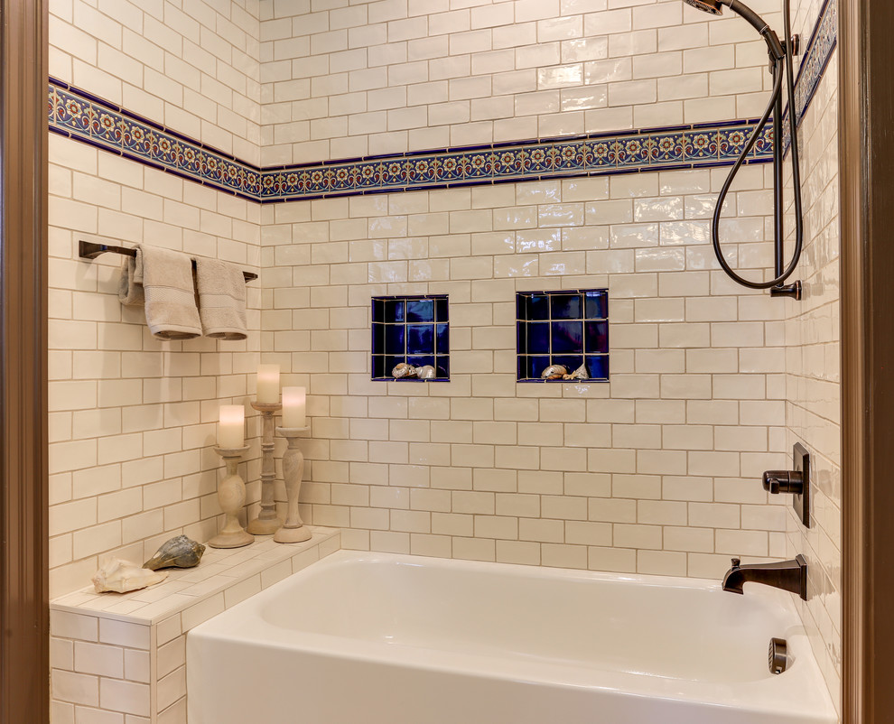 Inspiration for a large mediterranean ensuite bathroom in Raleigh with raised-panel cabinets, medium wood cabinets, a built-in bath, a shower/bath combination, a two-piece toilet, white tiles, ceramic tiles, beige walls, vinyl flooring, a submerged sink, engineered stone worktops and grey floors.