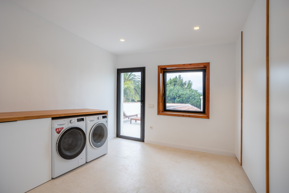 Large eclectic laundry room in Other.
