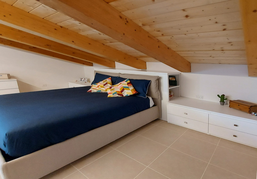 This is an example of a medium sized contemporary master bedroom in Rome with white walls, porcelain flooring, white floors and a wood ceiling.