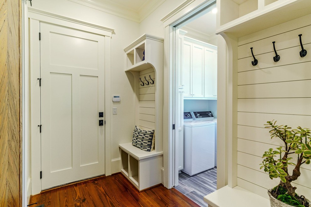 Mid-sized country mudroom in Other with white walls, dark hardwood floors, a single front door and brown floor.