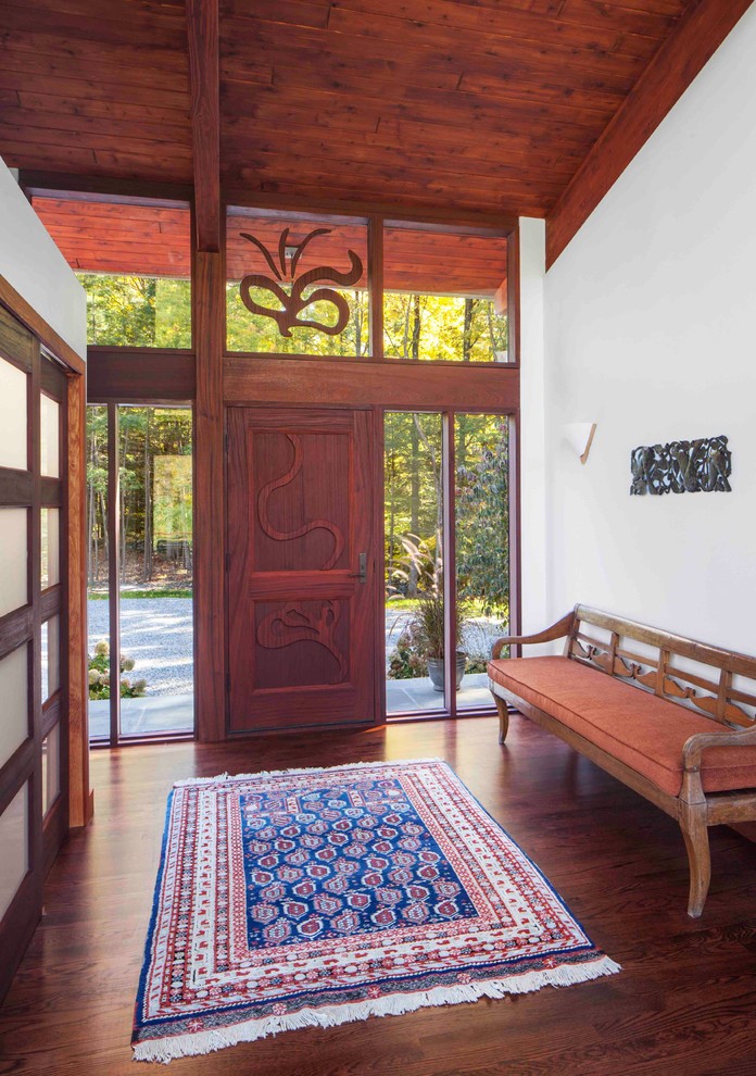 This is an example of a large country foyer in Boston with white walls, dark hardwood floors, a single front door, a dark wood front door and brown floor.