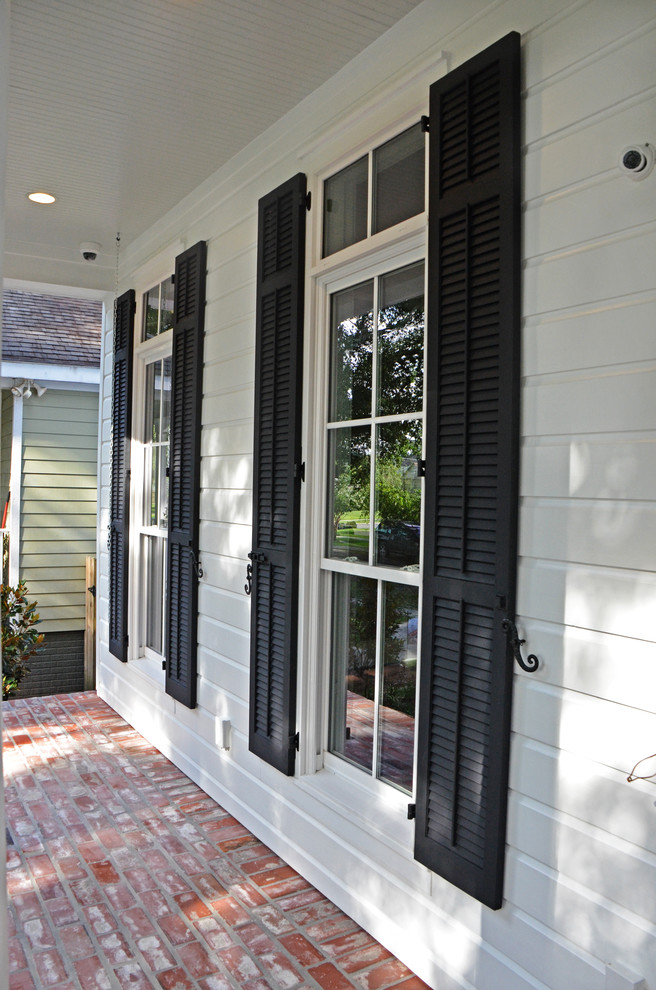 Inspiration for a mid-sized traditional white exterior in New Orleans with concrete fiberboard siding.