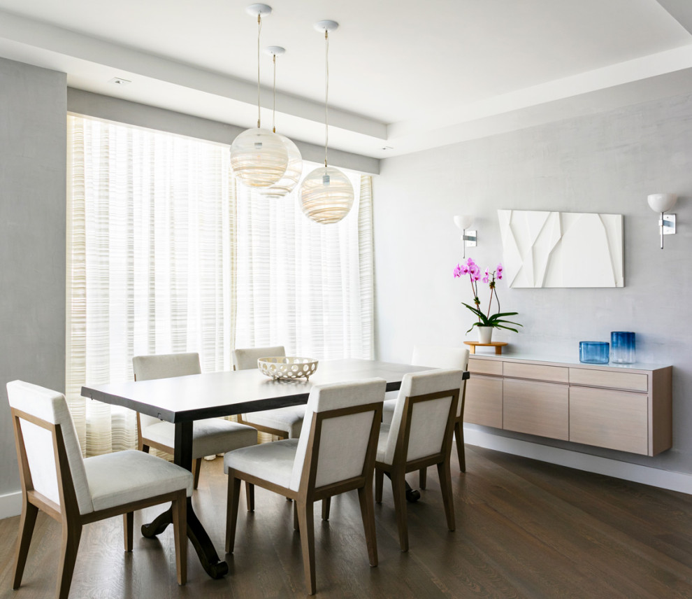 Mid-sized contemporary separate dining room in New York with beige walls, medium hardwood floors and no fireplace.