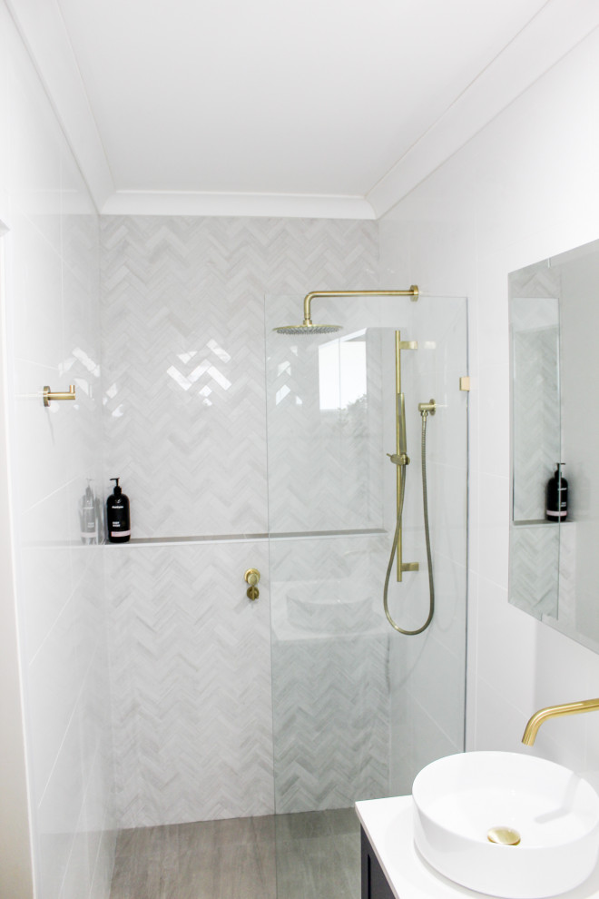 Mid-sized contemporary master bathroom in Perth with shaker cabinets, blue cabinets, an open shower, a one-piece toilet, white tile, ceramic tile, white walls, porcelain floors, a vessel sink, engineered quartz benchtops, grey floor, an open shower and white benchtops.