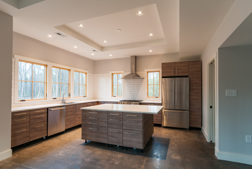 This is an example of a mid-sized country l-shaped kitchen pantry in Richmond with an undermount sink, flat-panel cabinets, light wood cabinets, granite benchtops, white splashback, porcelain splashback, stainless steel appliances, concrete floors, with island and multi-coloured floor.