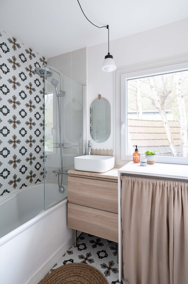 This is an example of a farmhouse bathroom in Paris with cement tiles, a built-in sink and a single sink.