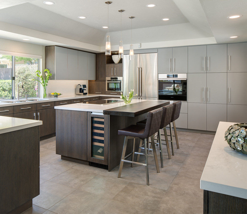 Inspiration for a large contemporary u-shaped eat-in kitchen in San Diego with a triple-bowl sink, flat-panel cabinets, dark wood cabinets, marble benchtops, white splashback, ceramic splashback, stainless steel appliances, ceramic floors, with island, multi-coloured floor, white benchtop and coffered.
