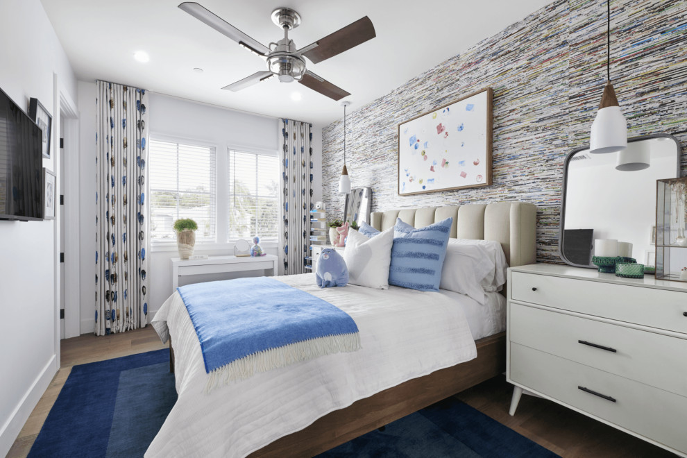 Large beach style kids' room in Orange County with white walls, medium hardwood floors, brown floor, vaulted and panelled walls.