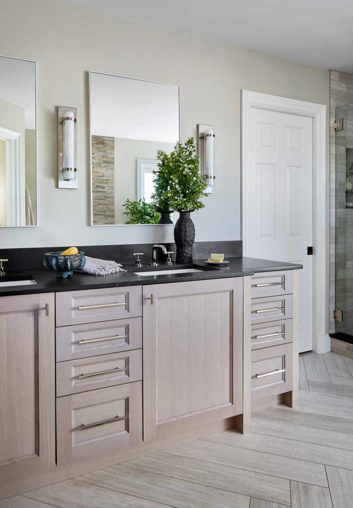 Inspiration for a medium sized classic ensuite bathroom in Denver with recessed-panel cabinets, grey cabinets, a freestanding bath, a corner shower, grey tiles, limestone tiles, limestone flooring, a submerged sink, soapstone worktops, grey floors, a hinged door, black worktops, an enclosed toilet, double sinks and a built in vanity unit.