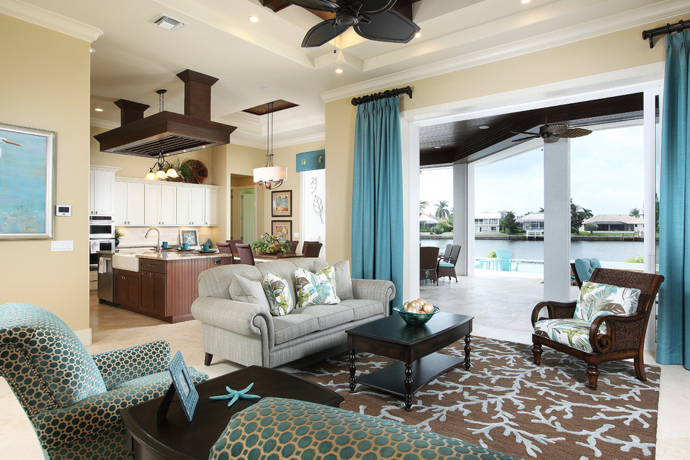 This is an example of a mid-sized beach style formal open concept living room in Miami with beige walls, travertine floors and no fireplace.