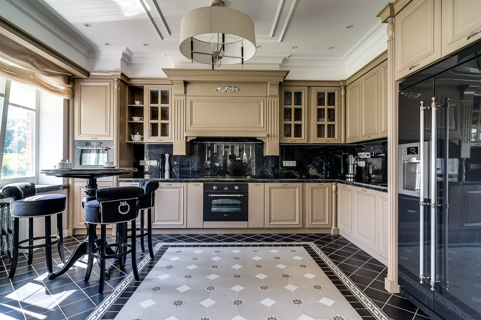 Inspiration for a traditional l-shaped eat-in kitchen in Saint Petersburg with raised-panel cabinets, black splashback, black appliances, no island, multi-coloured floor and beige cabinets.