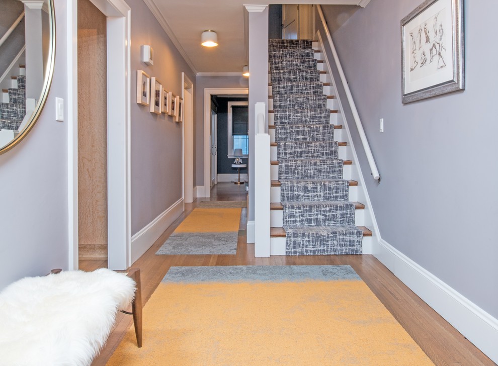 Mid-sized transitional hallway in Boston with grey walls, medium hardwood floors and brown floor.