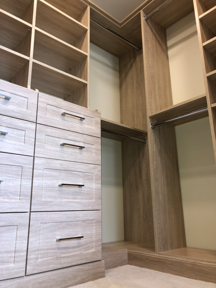 This is an example of a mid-sized traditional storage and wardrobe in Grand Rapids with shaker cabinets, light wood cabinets, carpet, beige floor and coffered.