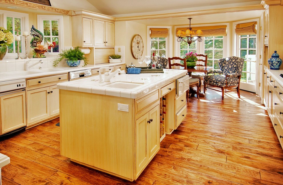 Mid-sized traditional galley separate kitchen in Seattle with tile benchtops, a double-bowl sink, shaker cabinets, light wood cabinets, white splashback, ceramic splashback, medium hardwood floors and with island.