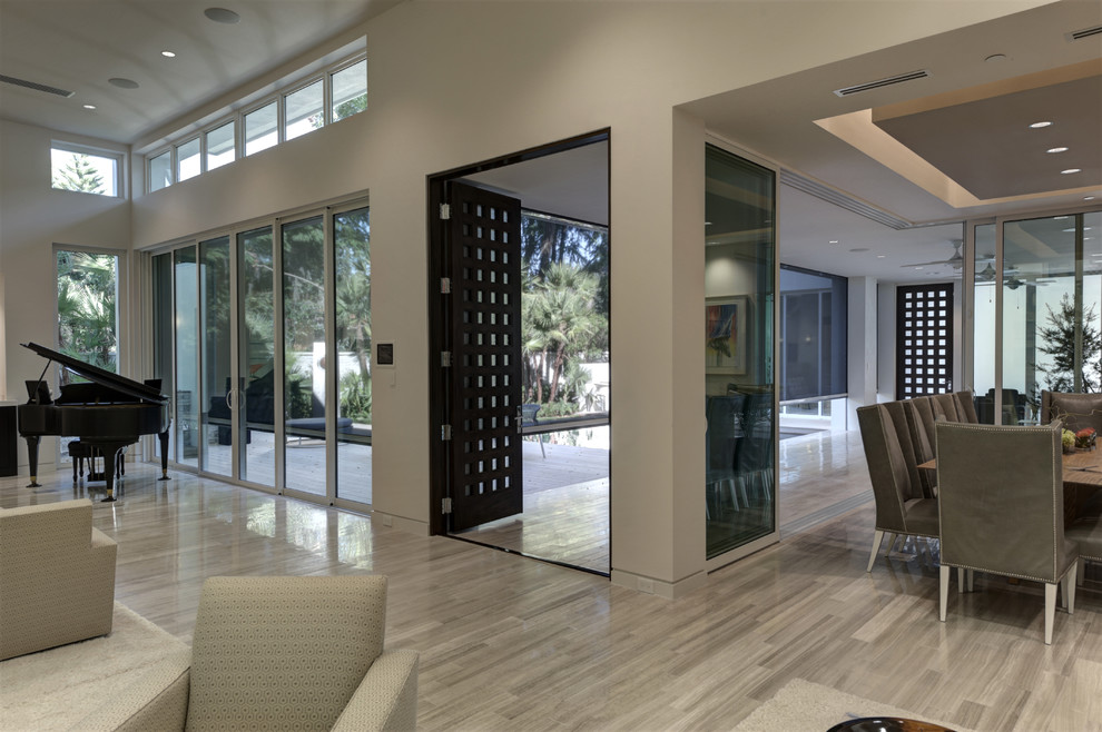 Large modern open concept living room in Orlando with a music area, white walls, porcelain floors and grey floor.