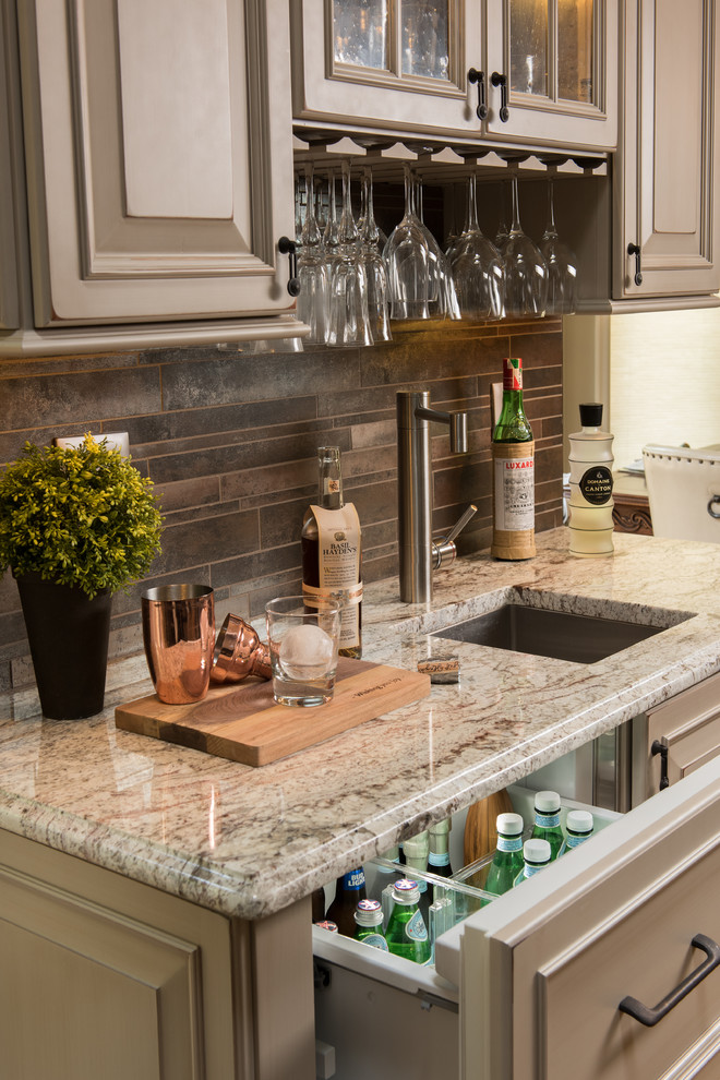 Kitchen - huge transitional galley light wood floor kitchen idea with raised-panel cabinets, gray cabinets, quartz countertops, multicolored backsplash, stone tile backsplash, stainless steel appliances and an island